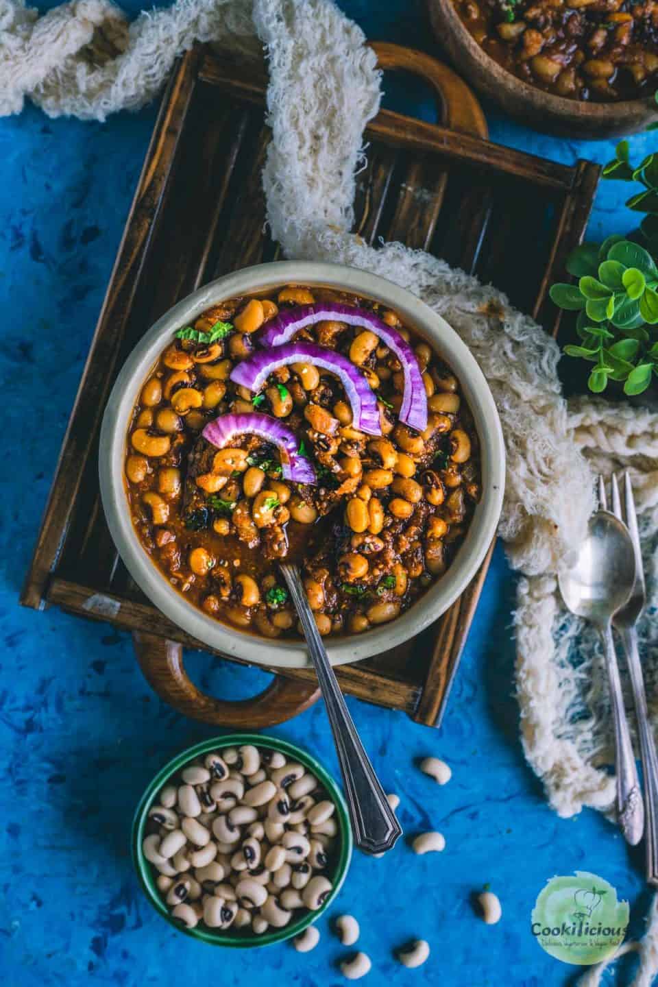 Chettinad Black Eyed Peas Curry  served in a round bowl with a spoon in it