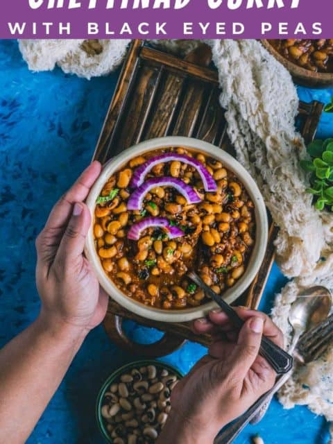 One hand holding the bowl while the other hand digs into a bowl of Chettinad Black Eyed Peas Curry with a spoon and text at the top and bottom