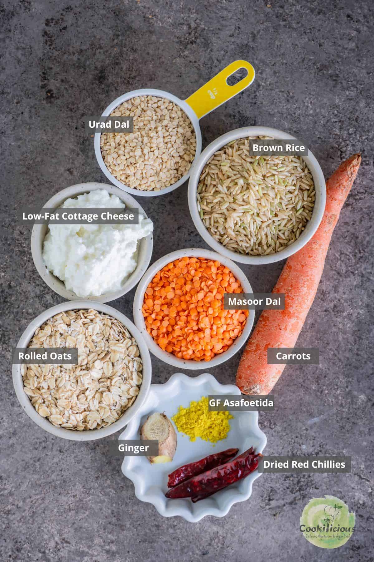 all the ingredients needed to make oats dosa placed on a table with labels on them.