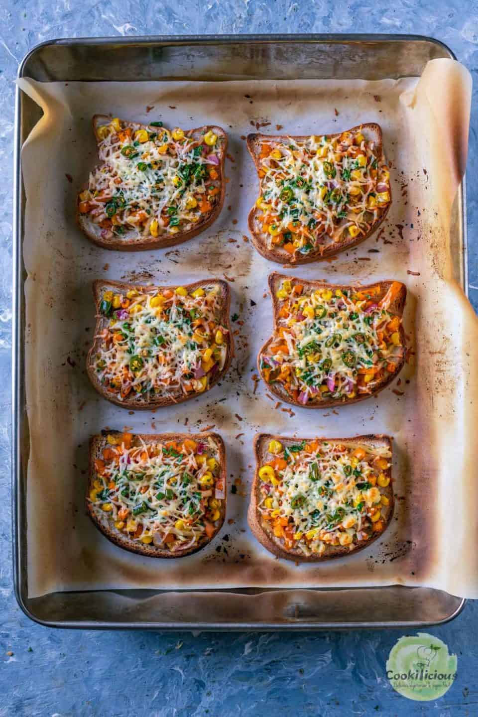 6 Vegan Chilli Cheese Corn Toasts freshly out of the oven and in a baking tray