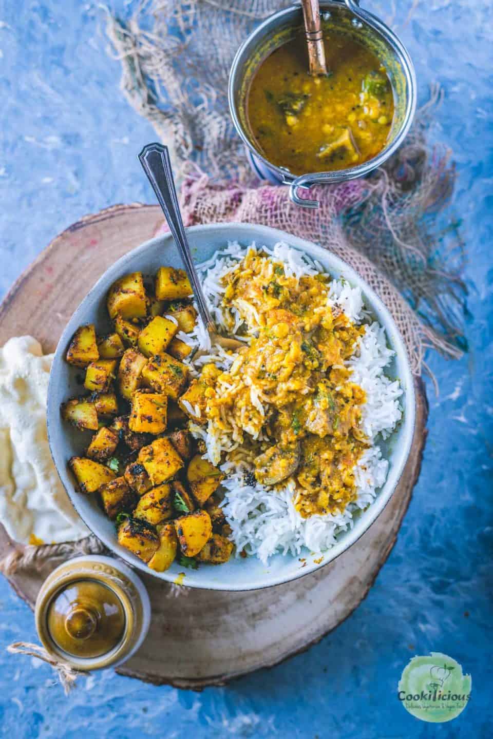 rice, potato curry and Arachuvitta Sambhar served in a bowl