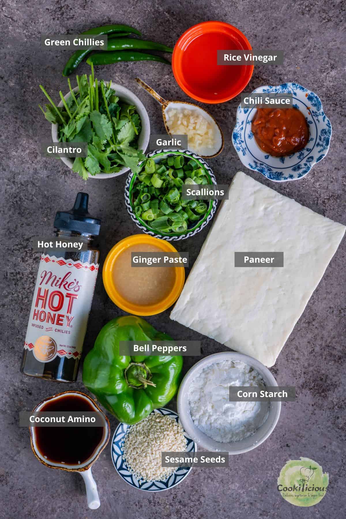 all the ingredients needed to make Chilli Paneer placed on a table with labels on them.