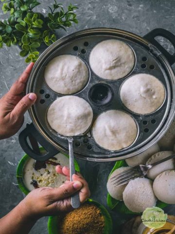 Top view of idli being pulled out of basket