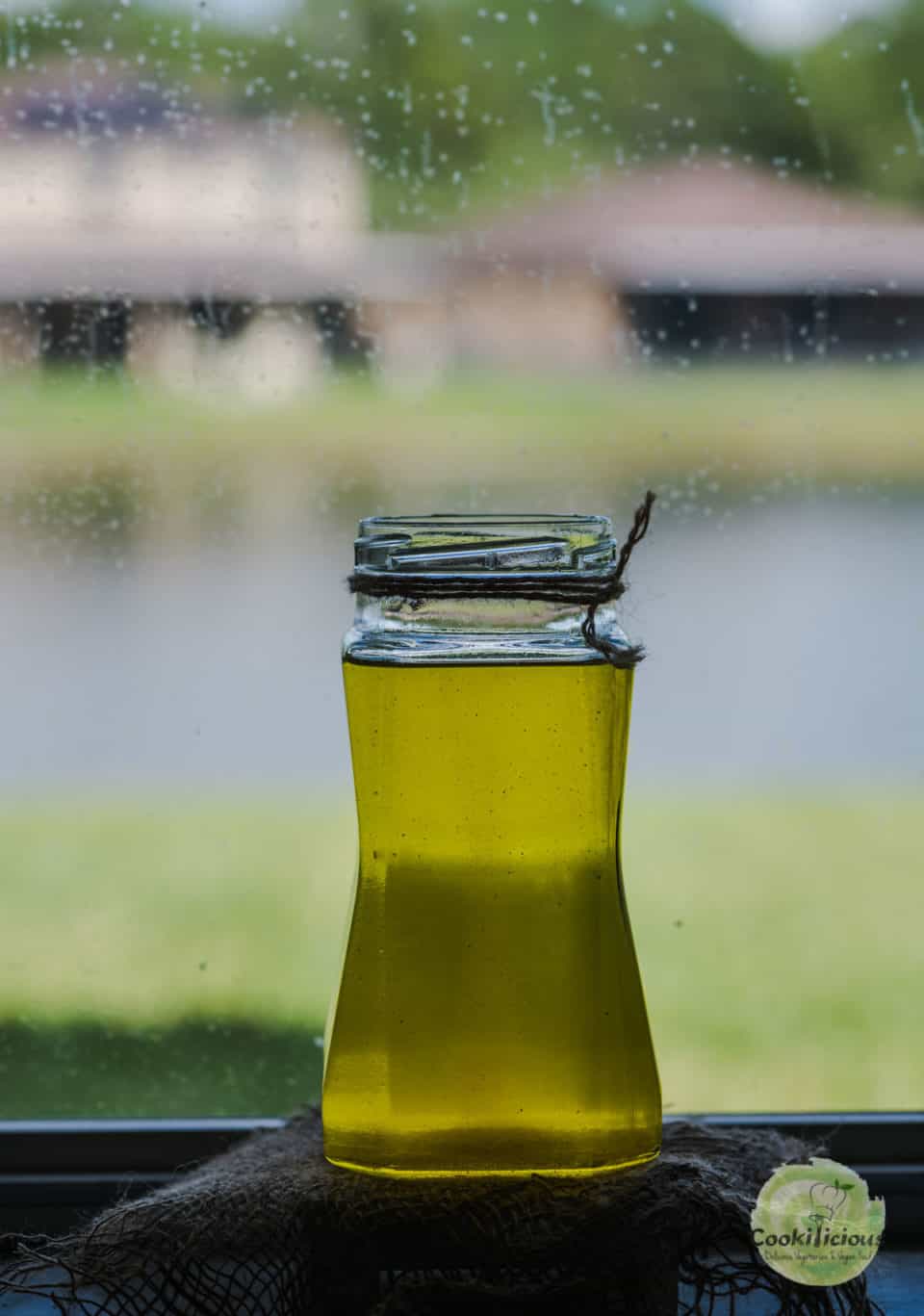 a tall glass jar filled with vegan ghee