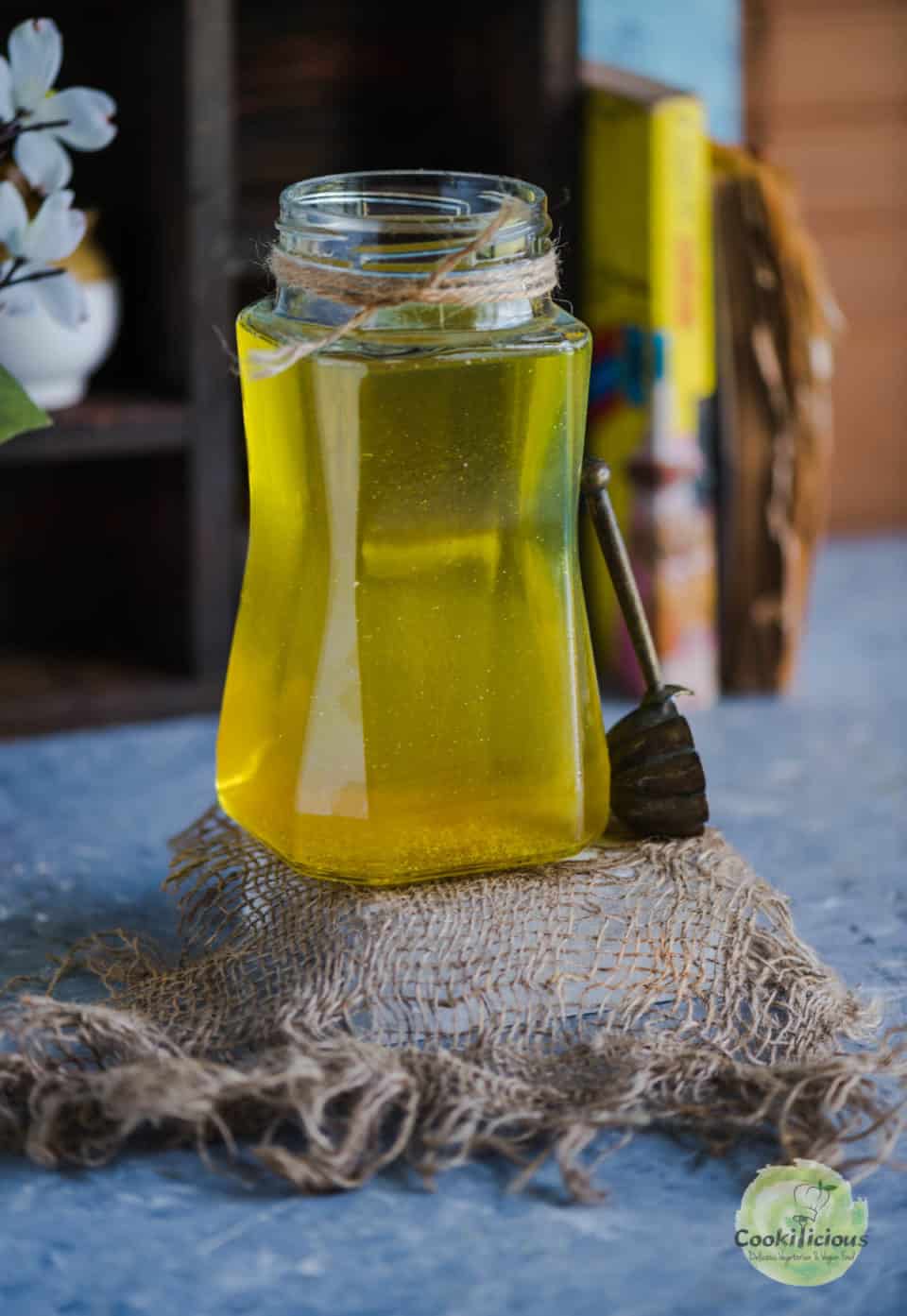 A spoon resting on a jar of dairy free ghee