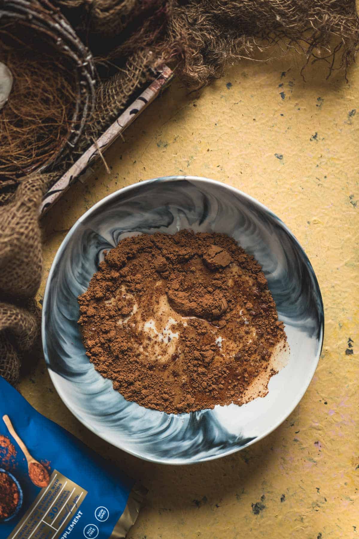 Room temperature oat milk being added to the chocolate batter.