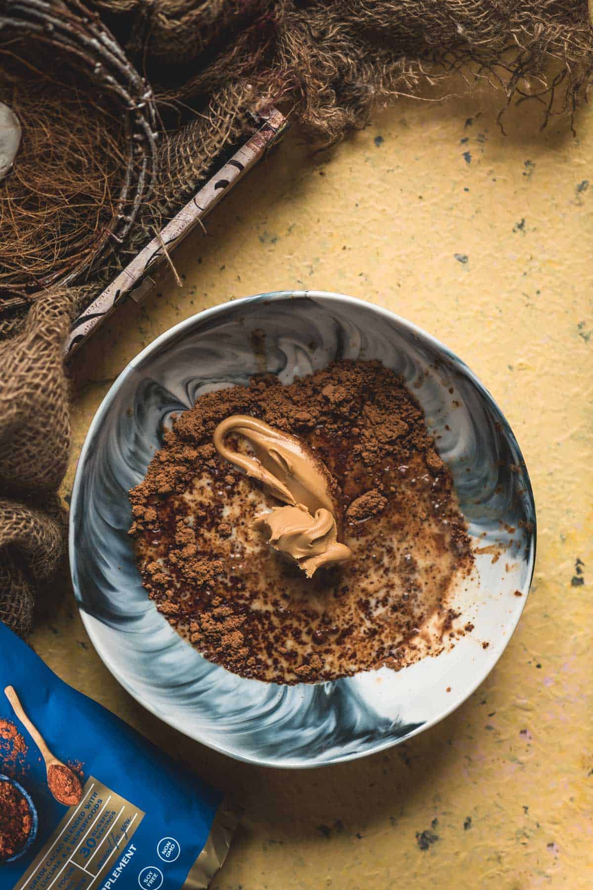 Cacao butter added to the vegan chocolate bar mixture in a bowl.