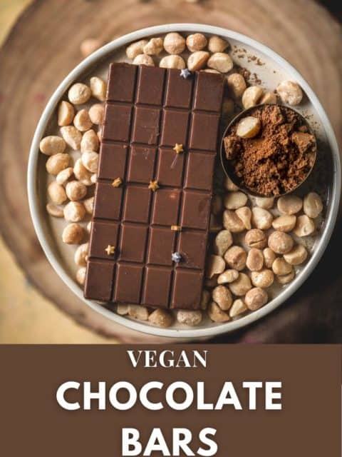 Vegan Chocolate Macadamia Bar served on a platter with macadamia nuts around it and text at the bottom