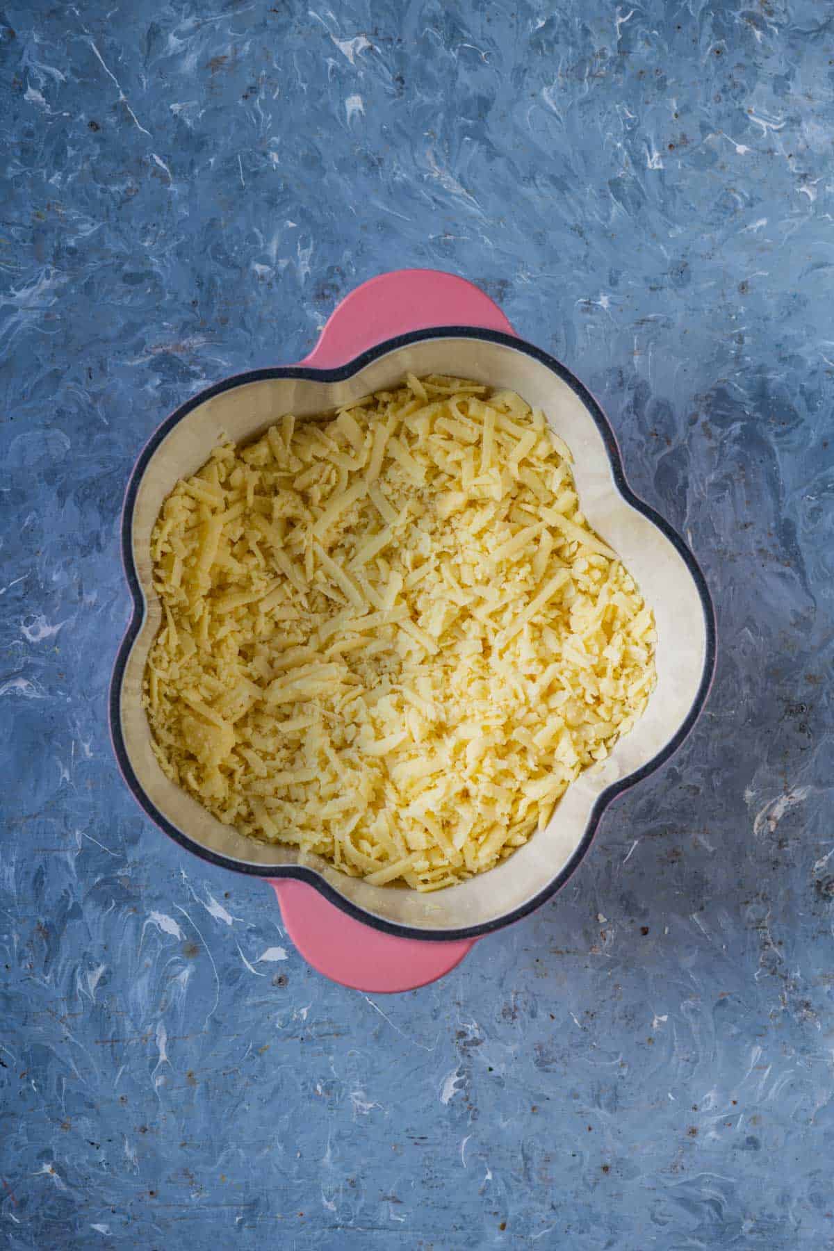 Grated khoya melting into ghee in a pan on low heat.