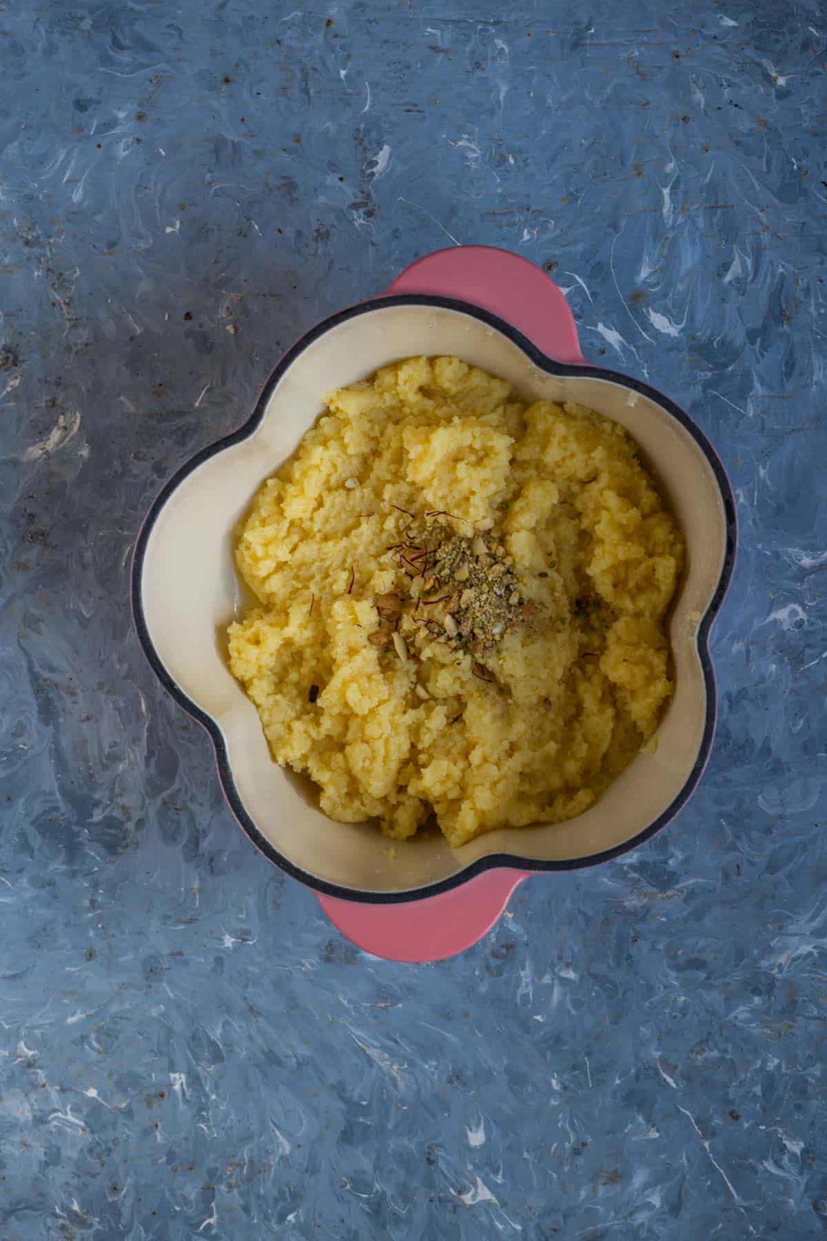 Chopped nuts and saffron strands added to khoya mixture.