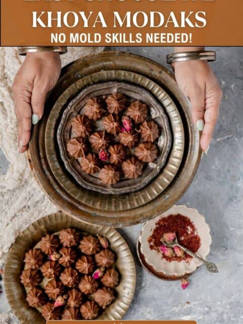 Pinterest pin graphic reading "Easy Chocolate Khoya Modaks, No Mold Skills Needed" over two hands holding a plate of chocolate modak.