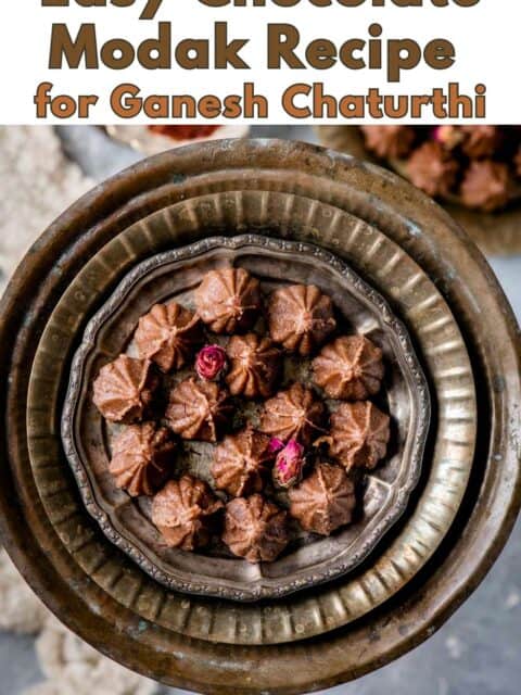 Pinterest pin graphic reading "Easy Chocolate Modak Recipe for Ganesh Chaturthi" over a plate of chocolate modak on a vintage tray.