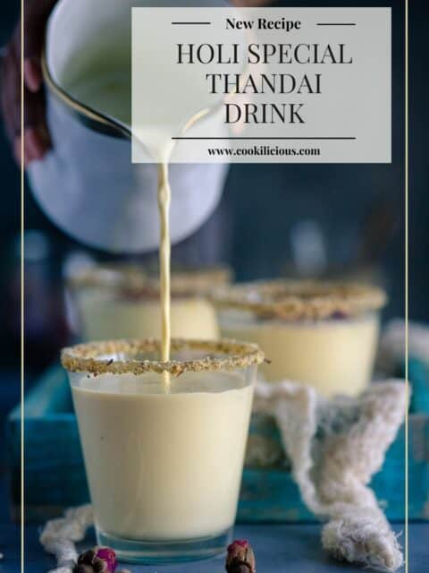 a hand pouring thandai into a glass and text at the top