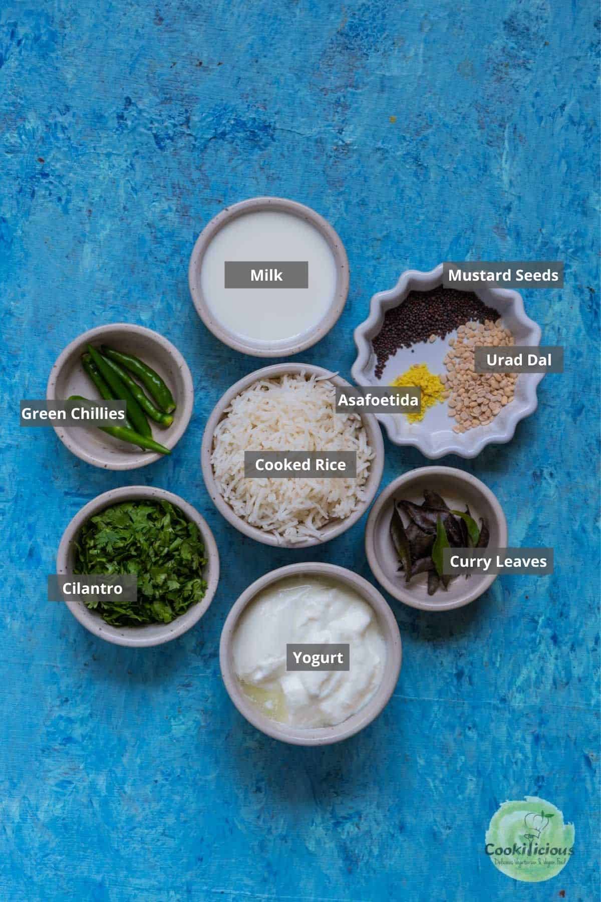 all the ingredients needed to make curd rice placed on a table with labels on them
