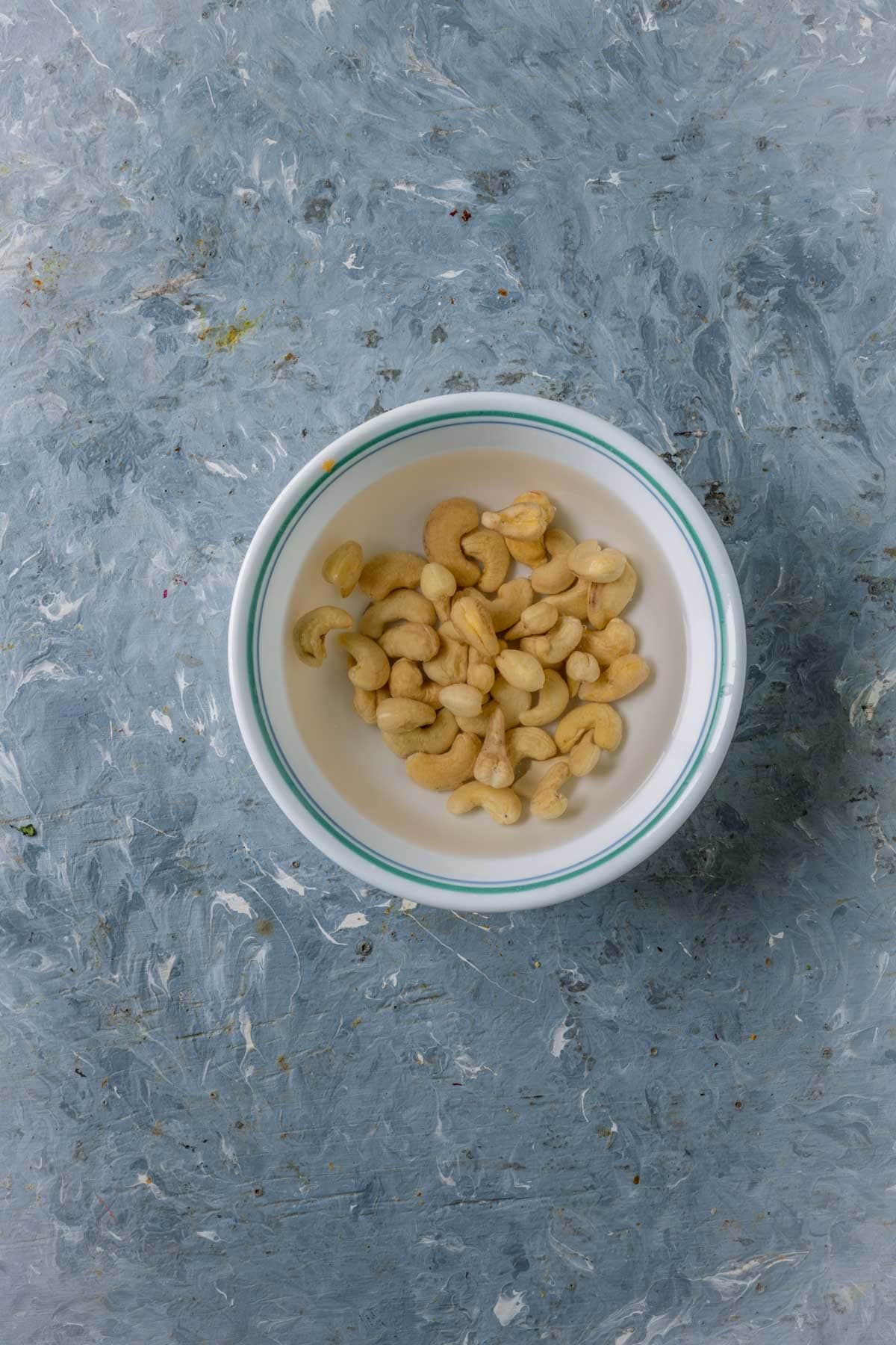 Cashews soaking in lukewarm water for creamy mushroom curry paste.