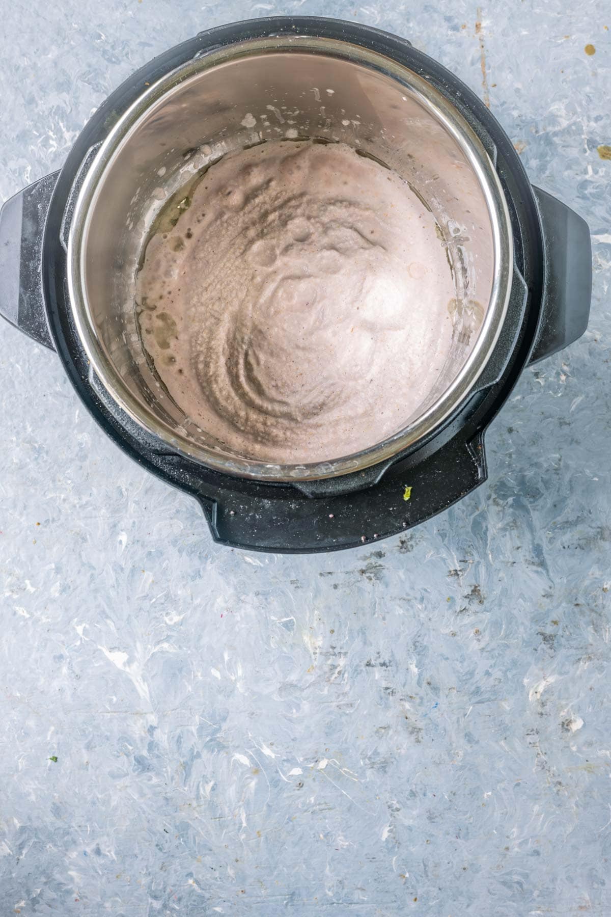 Cooking cashew-onion paste in Instant Pot on sauté mode.