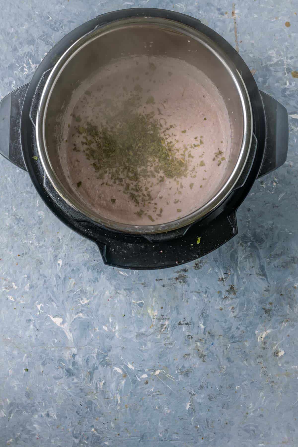 Adding crushed kasuri methi to the mushroom curry base.