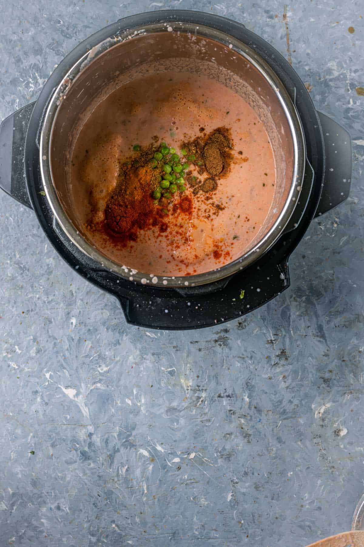 Adding Indian spices to the mushroom curry base.