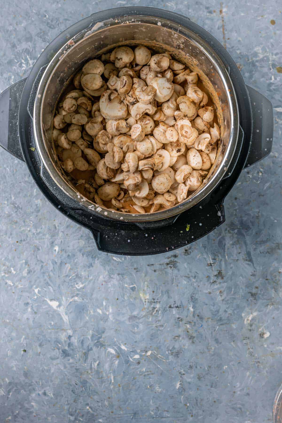Button mushrooms added to curry in Instant Pot.