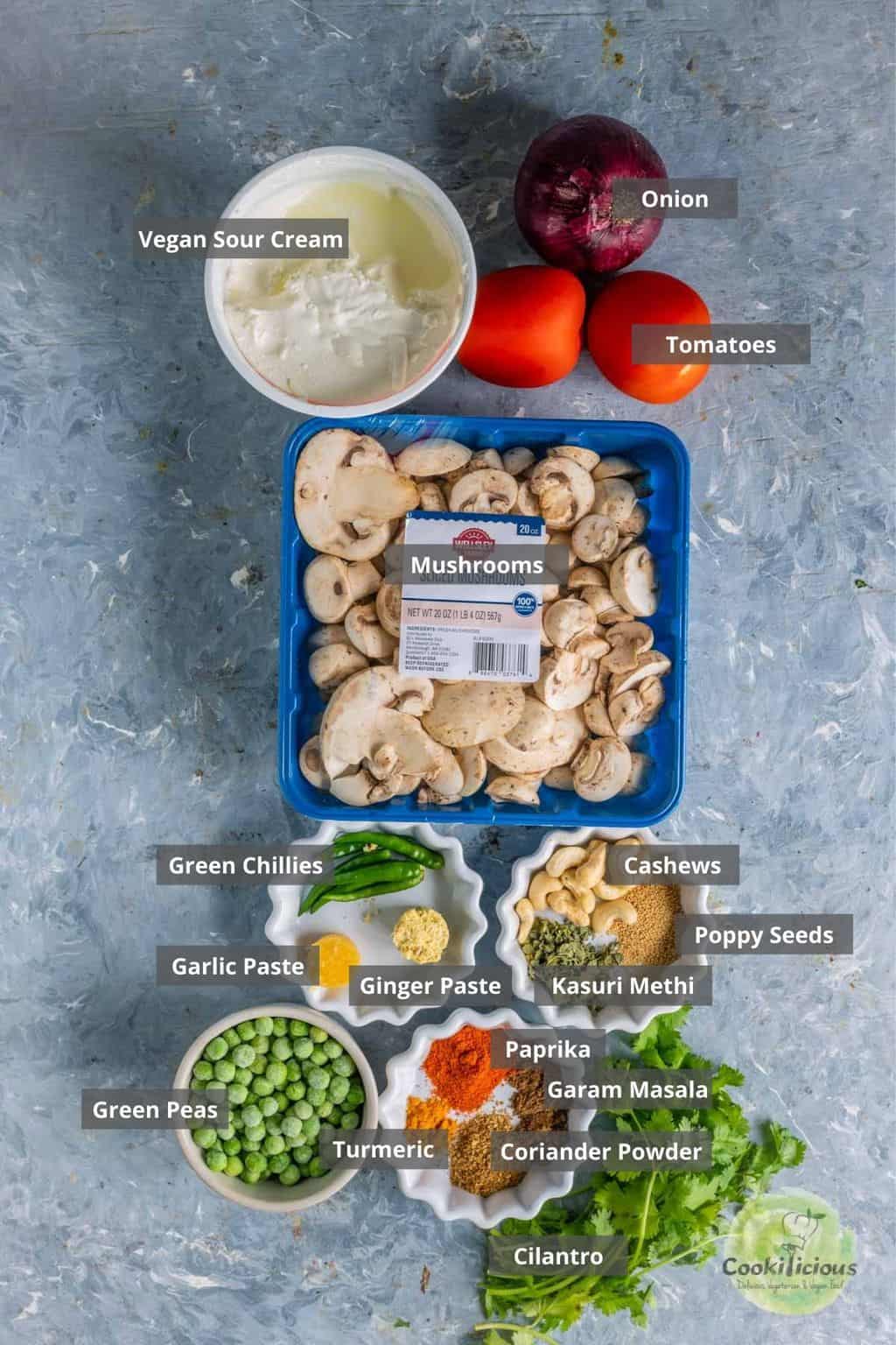 all the ingredients needed to make vegan Mushroom Masala placed on a table with labels on them.