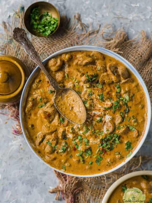 a bowl of Mushroom Masala with a spoon resting on top