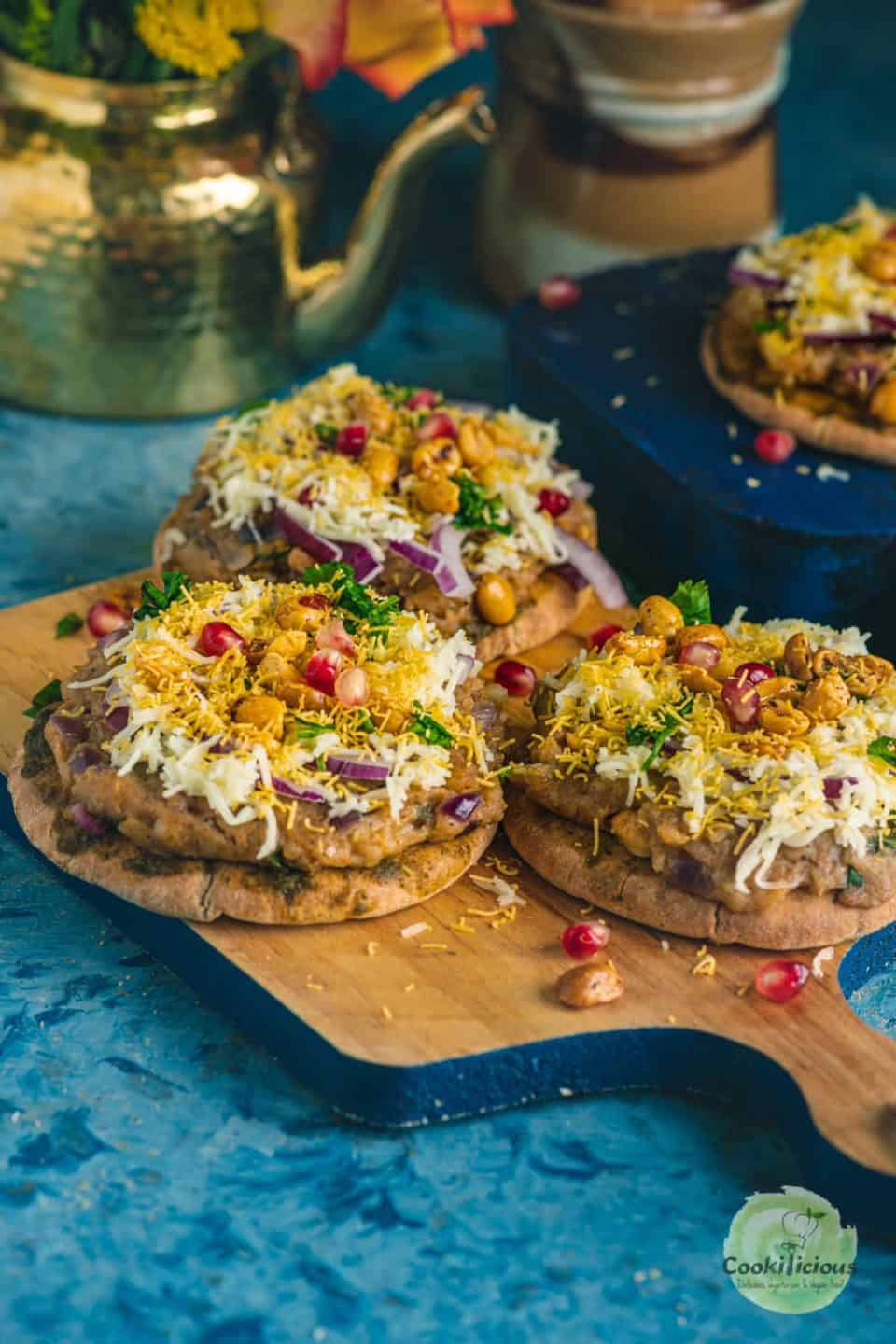 3 Dabeli Pita Bread Pizzas served on a wooden platter