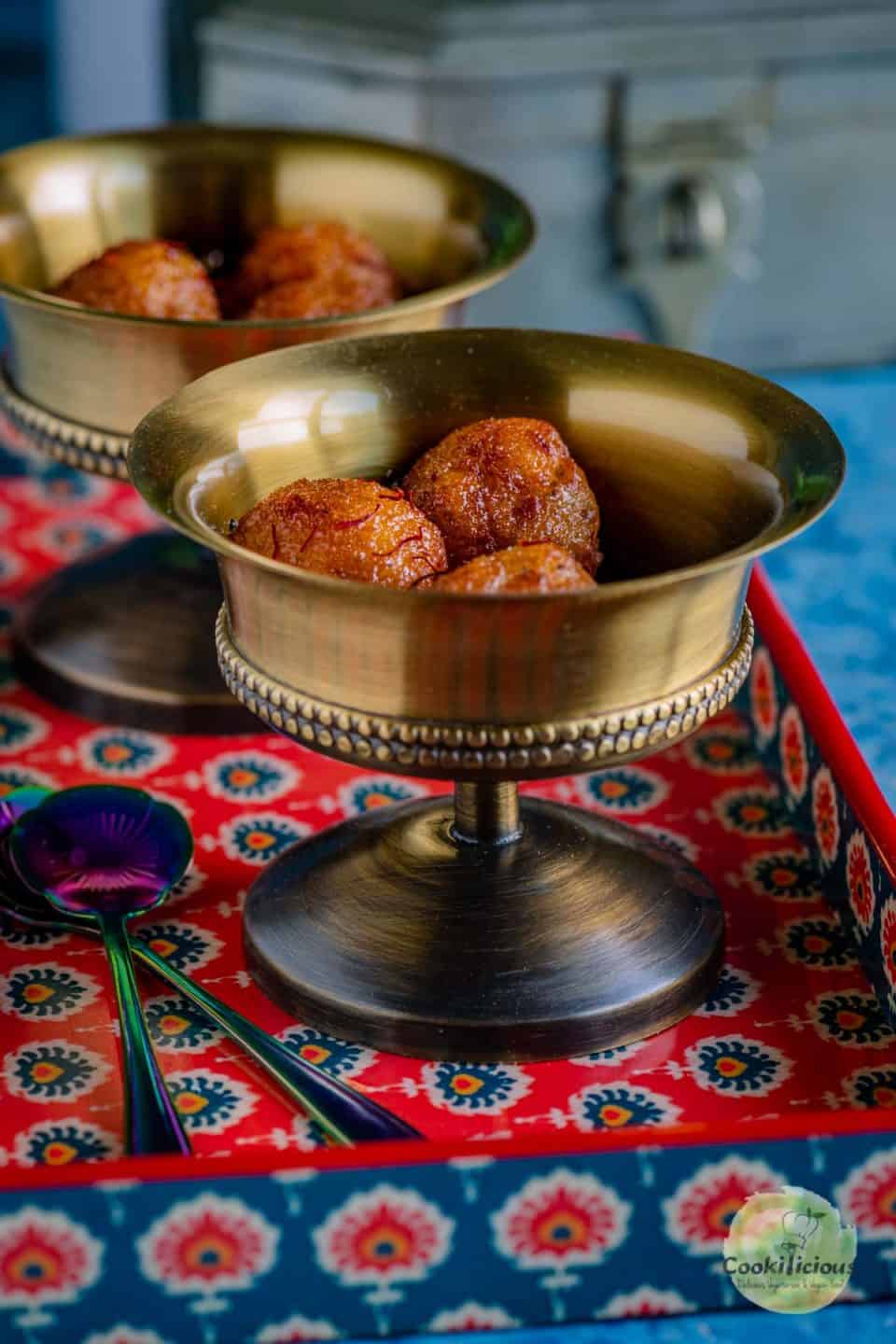 a servig bowl filled with bread gulab jamuns