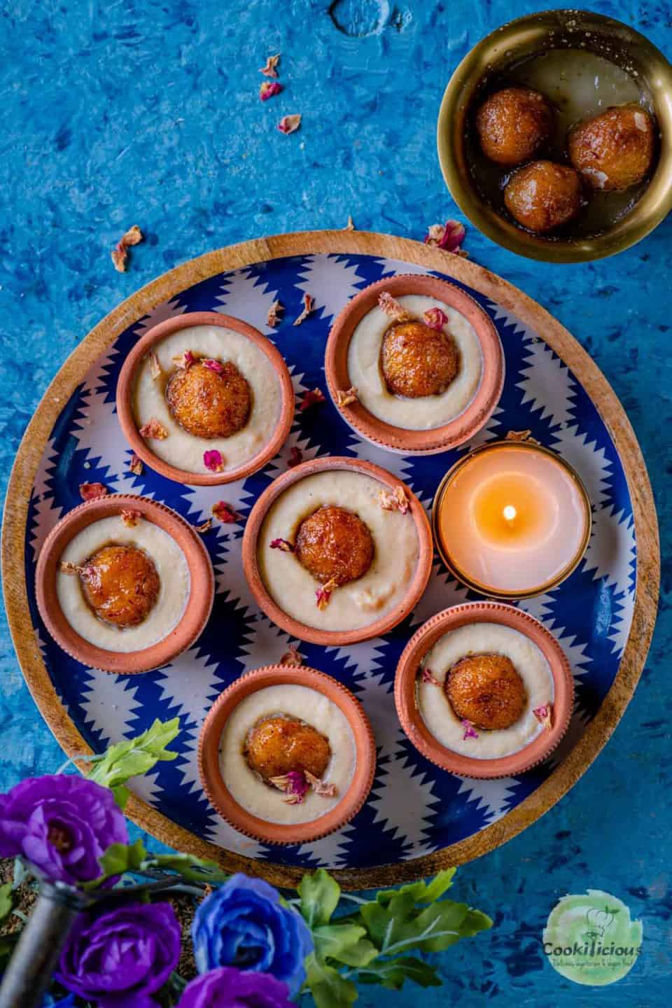 one round tray filled with Gulab Jamun Malai Matka Kulfis