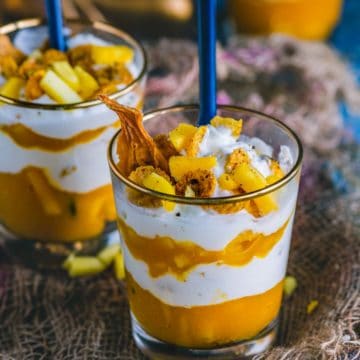 Mango Cranachan served in jars with spoons in it