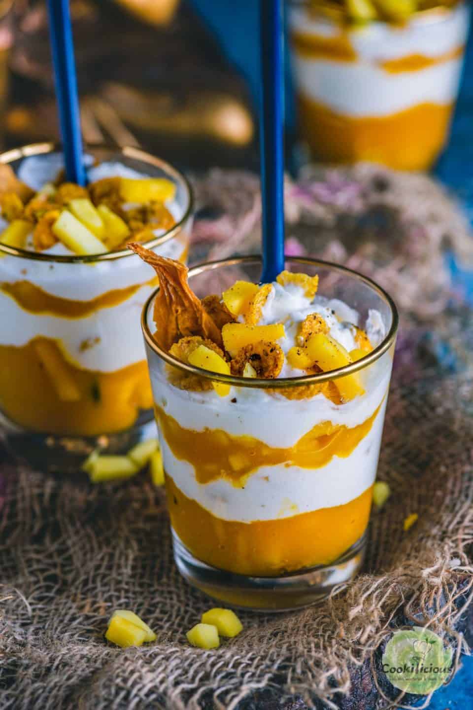 Mango Cranachan served in jars with spoons in it