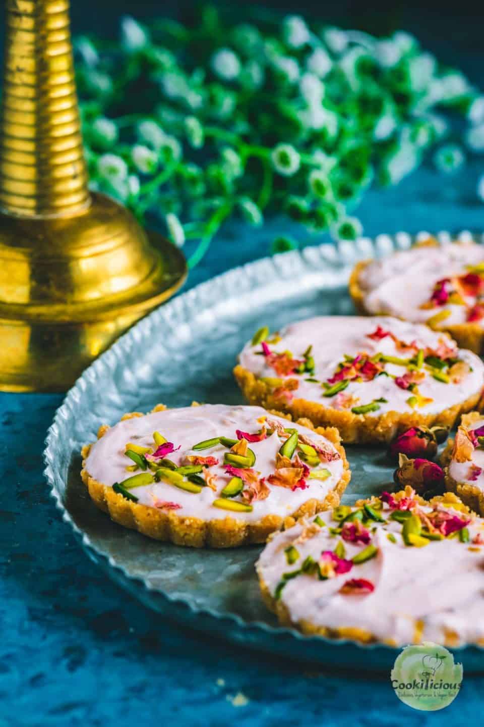 a couple of Gulkand Shrikhand Sweet Tarts served in a tray