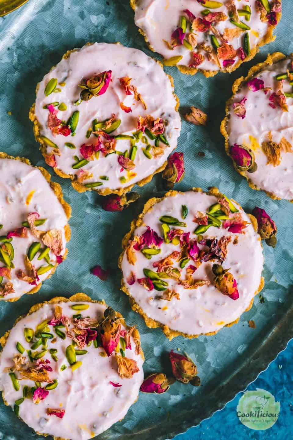 top view of a platter of Gulkand Shrikhand Sweet Tarts