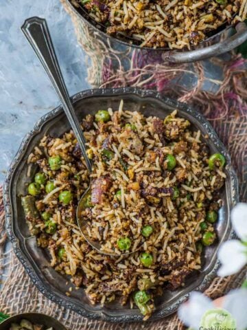 a plate filled with Pistachio Mint Rice and a spoon in it