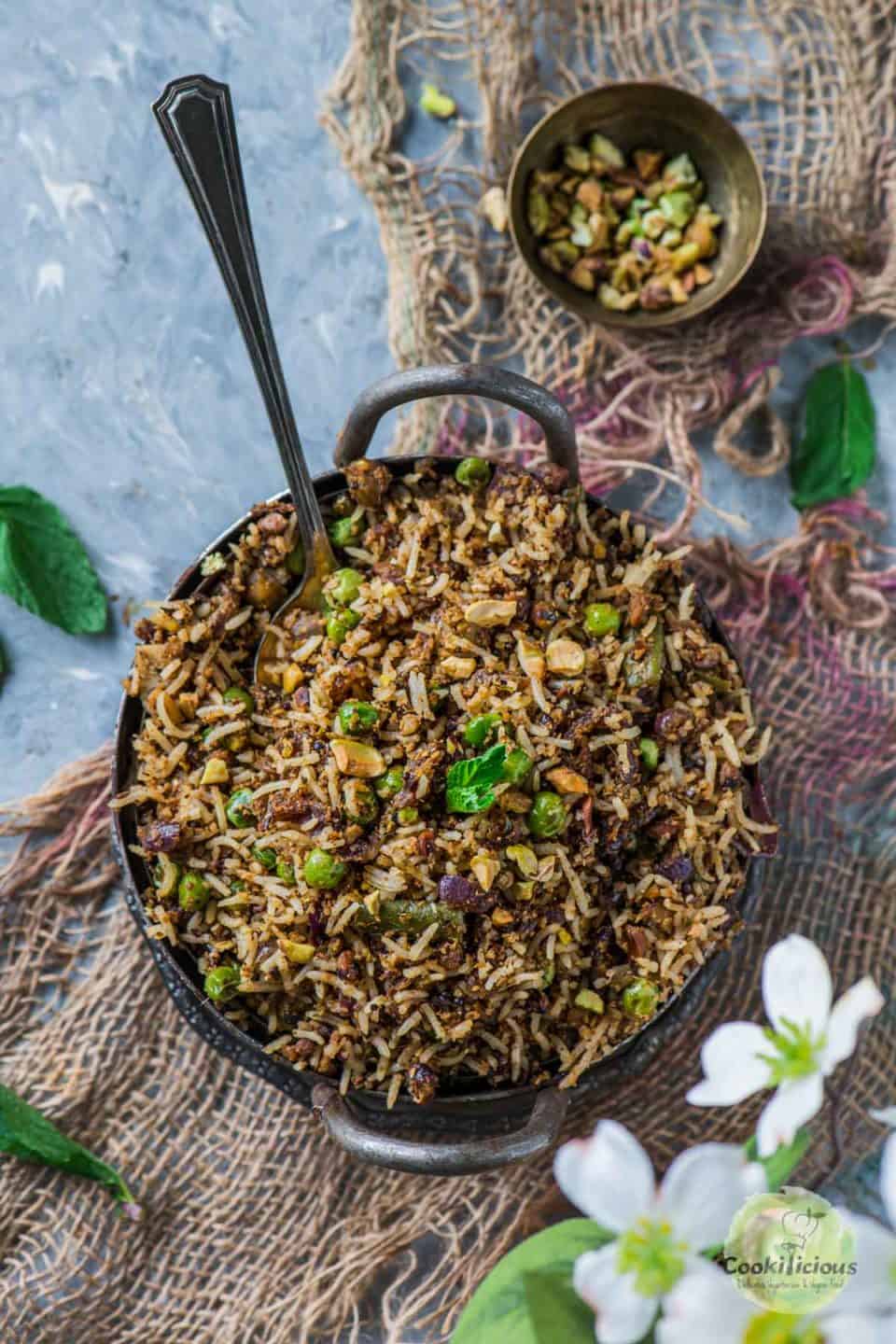Pistachio Mint Rice served in a small kadai with a spoon in it