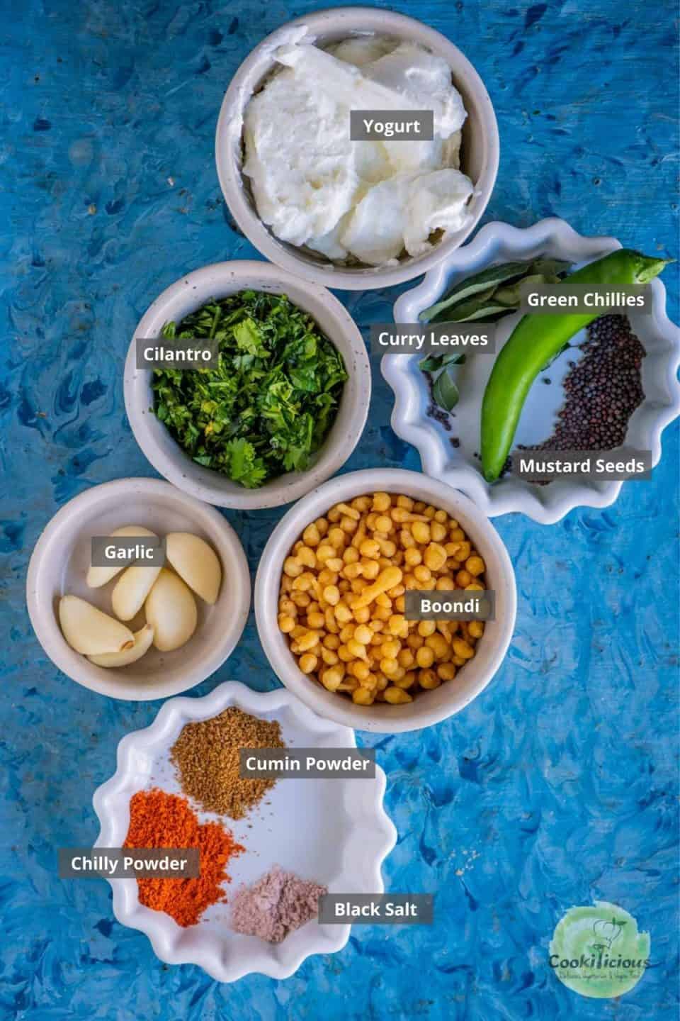 all the ingredients needed to make Burani Boondi Raita placed on a table with labels on them