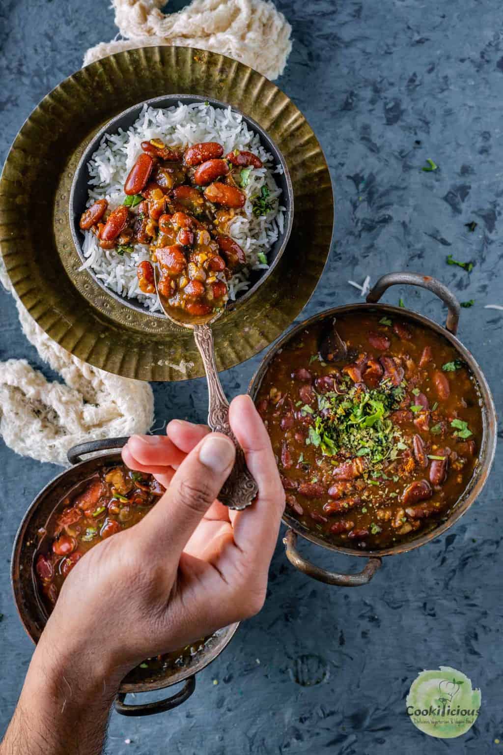 A spoonful of Instant pot rajma masala over a bowl of rice