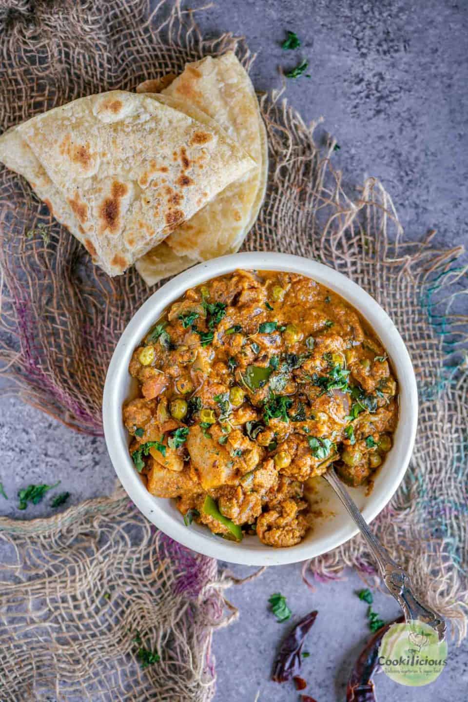 Veg Kolhapuri Recipe | Mixed Veg Curry served in a round bowl with chapati on the side