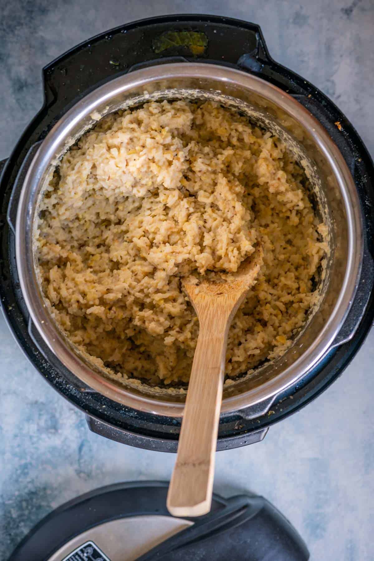 Cooked Ven Pongal being mashed to create a creamy South Indian Pongal consistency.