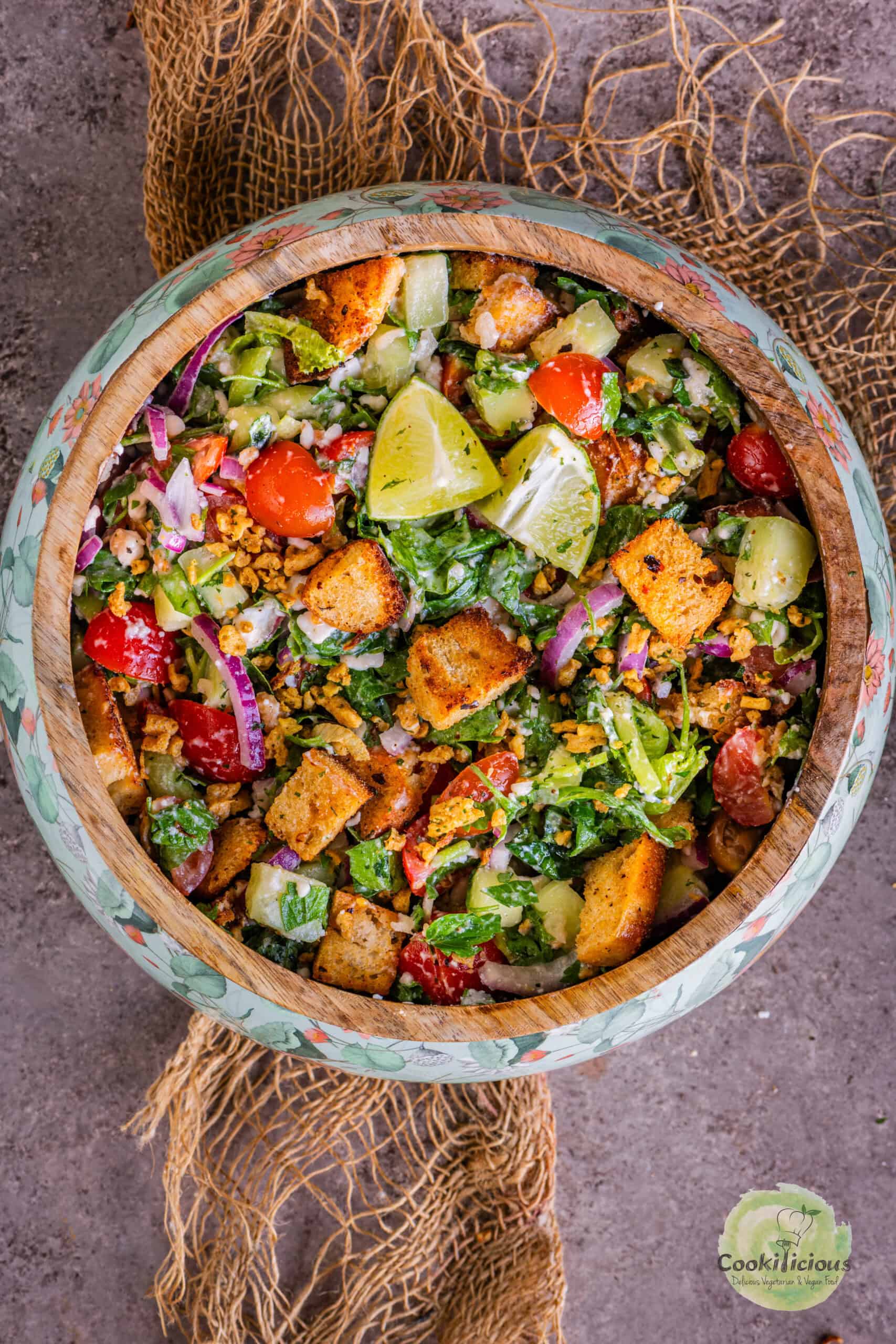 Cucumber Tomato and Feta Salad served with croutons and lemon wedges.