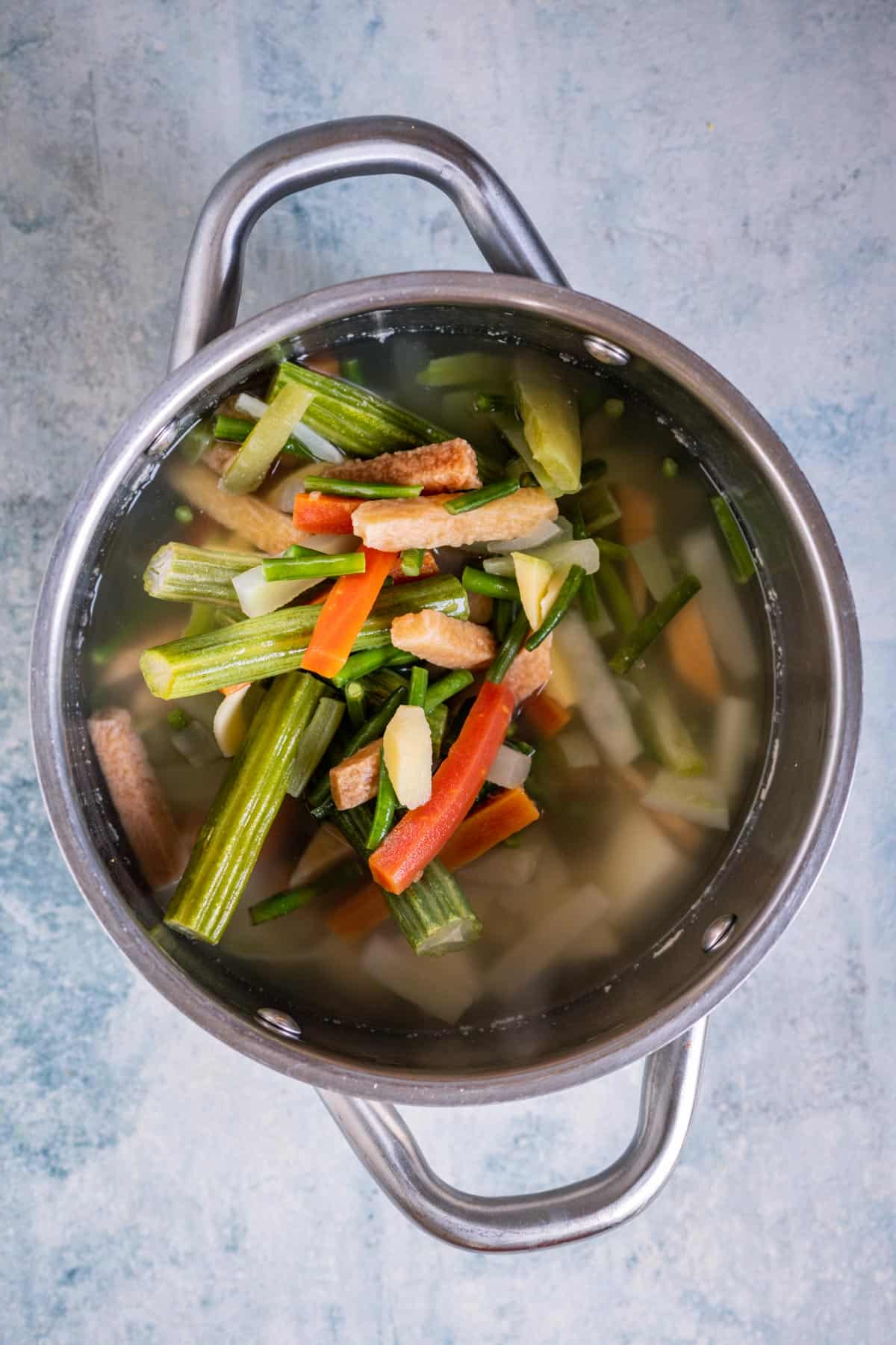 Mixed vegetables added to the pot and boiling until tender for aviyal.