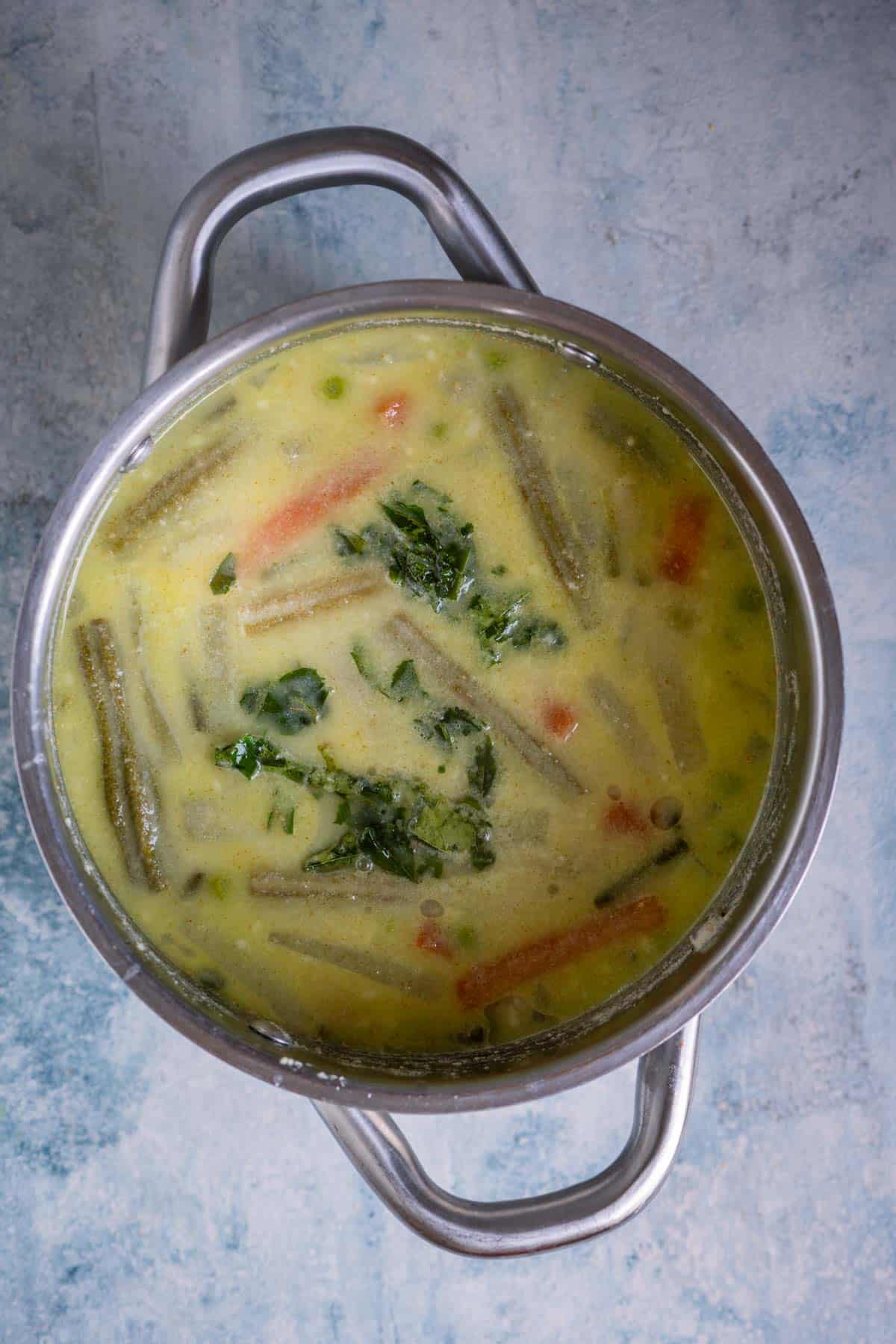 Avial simmering with curry leaves and coconut oil drizzled on top.