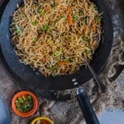 Veg Hakka Noodles in a wok with a fork in it