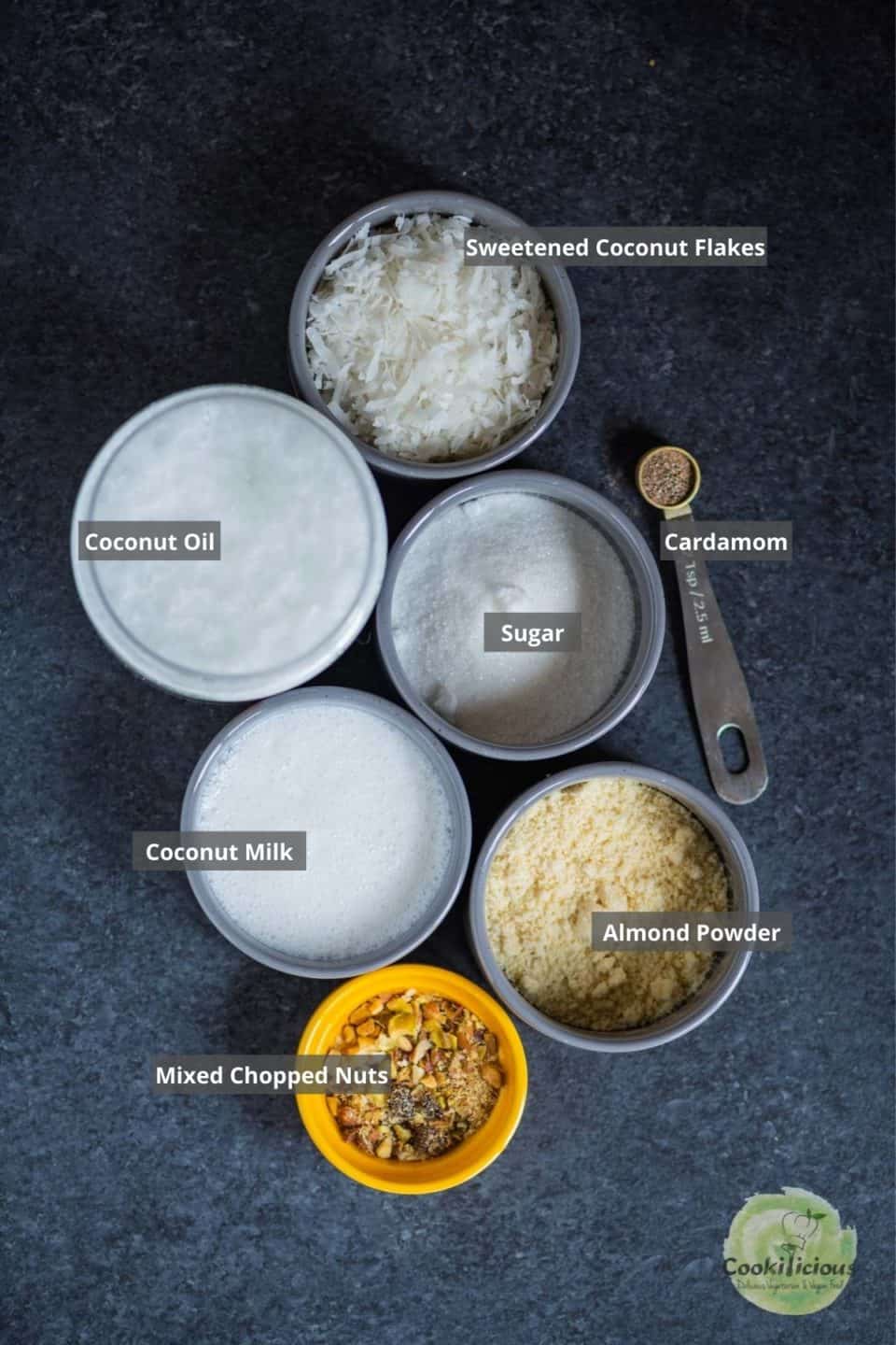 all the ingredients needed to make Vegan Coconut Ladoos placed on a table with labels on them