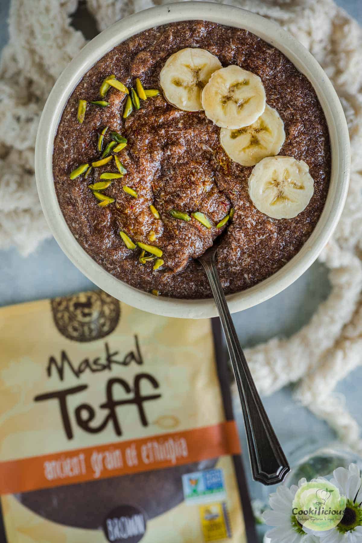 Vegan Teff Kheer Porridge served in a bowl with a packet of Maskal Teff on the side
