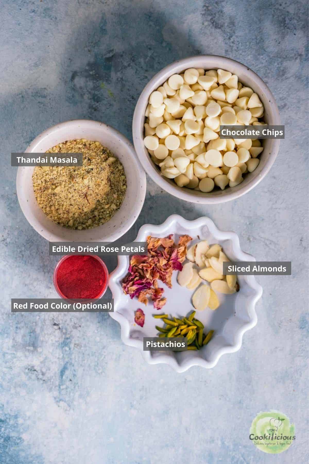 all the ingredients needed to make White Chocolate Thandai Bark Recipe placed on the table with labels on them