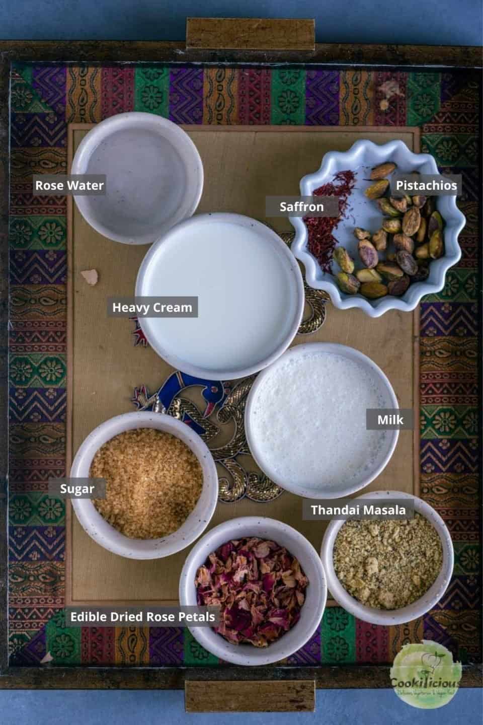 all the ingredients needed to make Thandai placed on a tray with labels on them