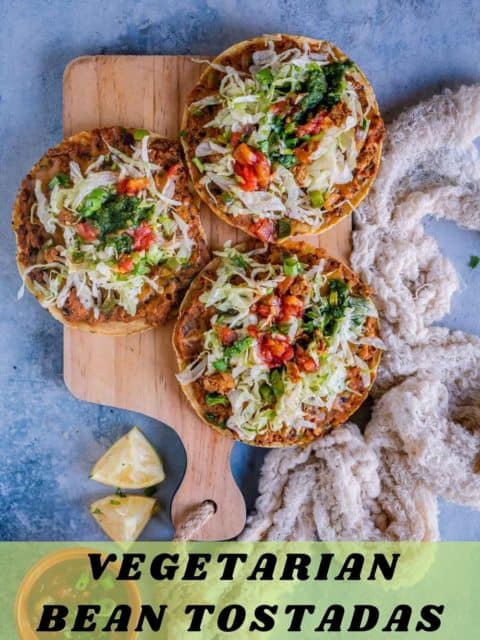 3 Vegan Corn Tostadas served on a wooden platter with text at the bottom