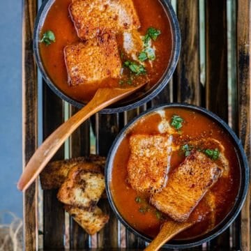 2 bowls of Vegan Tomato Soup served in wooden bowls