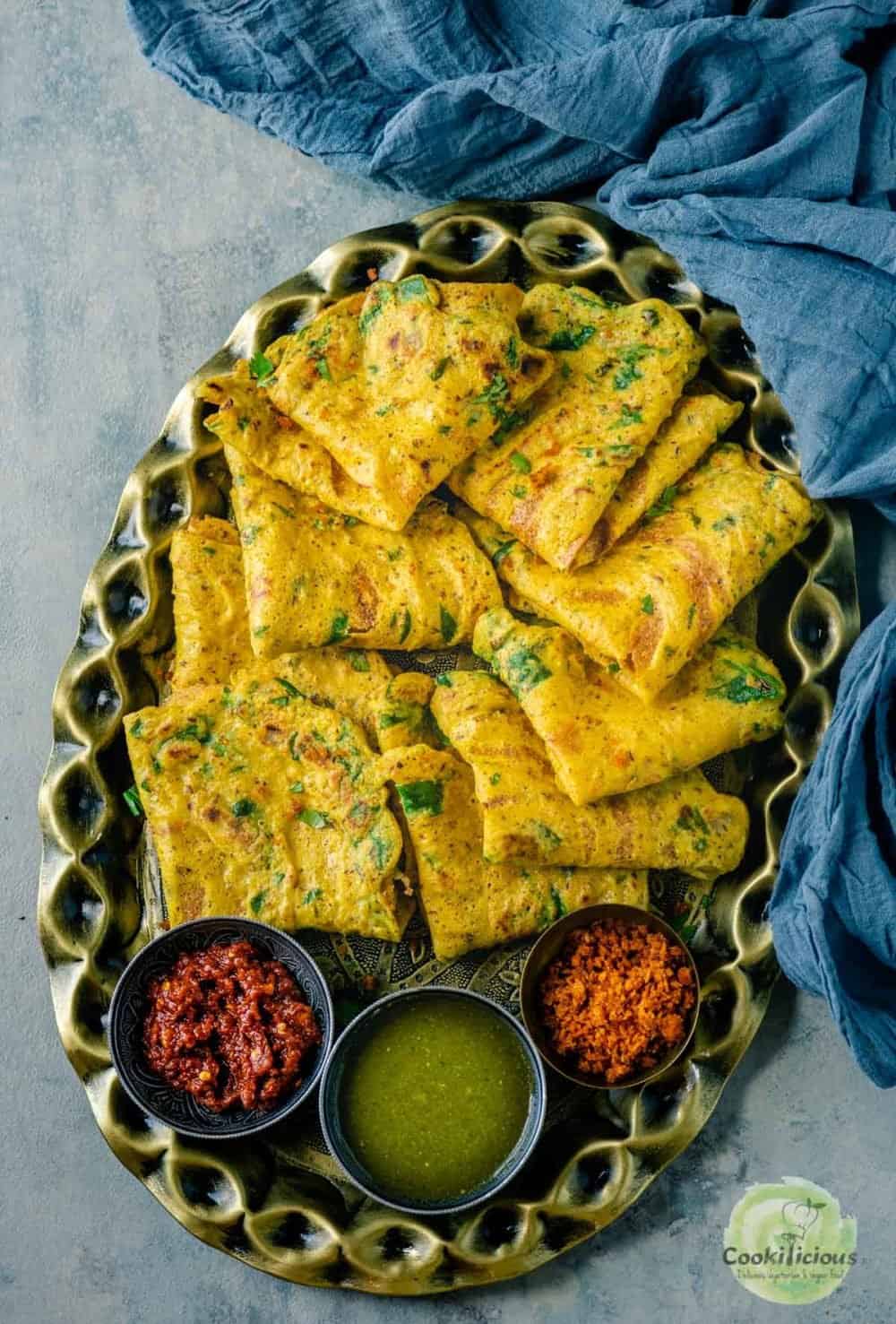 a large oval tray filled with Moong Dal Chillas