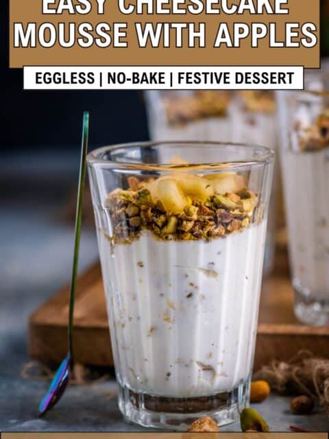 Apple Cheesecake Mousse served in a small glass with a spoon resting on it and text at the top and bottom.